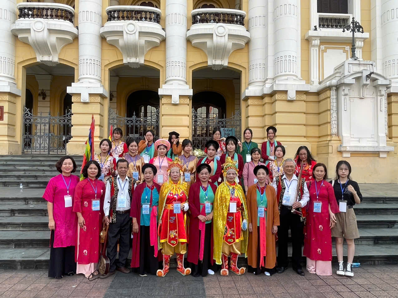 A group of people standing in front of a building  Description automatically generated