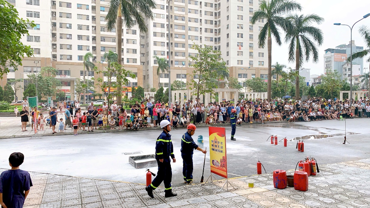 A group of people in front of a large crowd  Description automatically generated