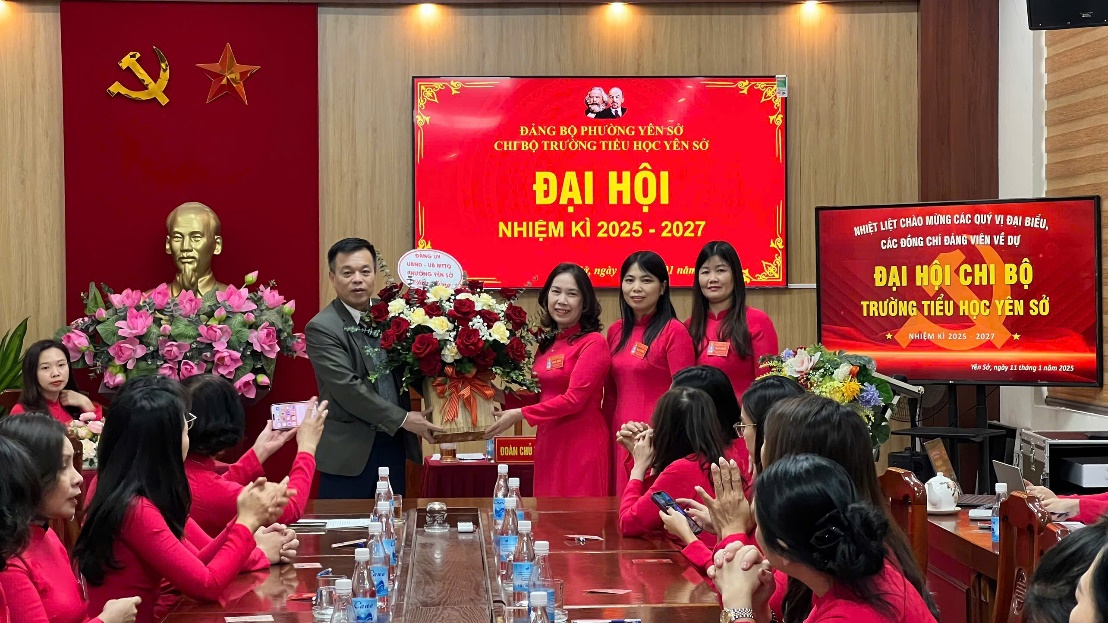 A group of people in red dresses standing around a table  Description automatically generated