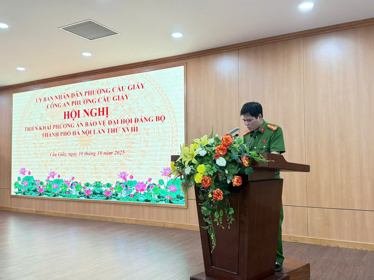 A person standing at a podium with flowers  AI-generated content may be incorrect.