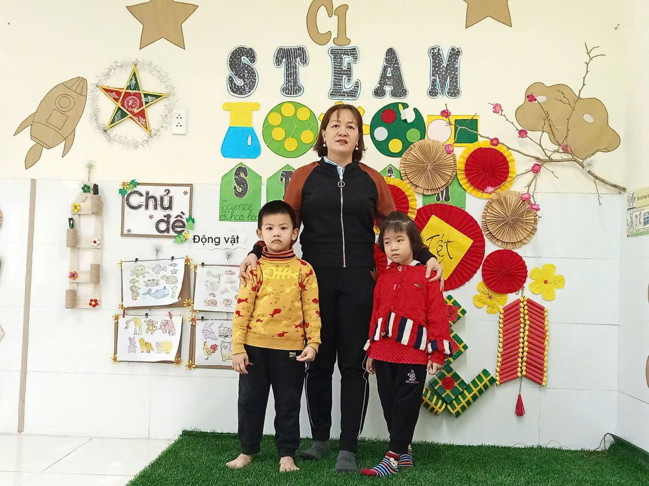 A person and two children posing for a picture  Description automatically generated