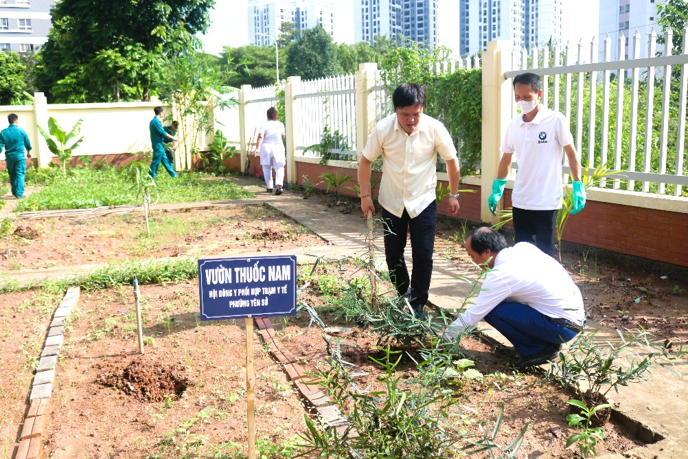 A group of people working in a garden  AI-generated content may be incorrect.