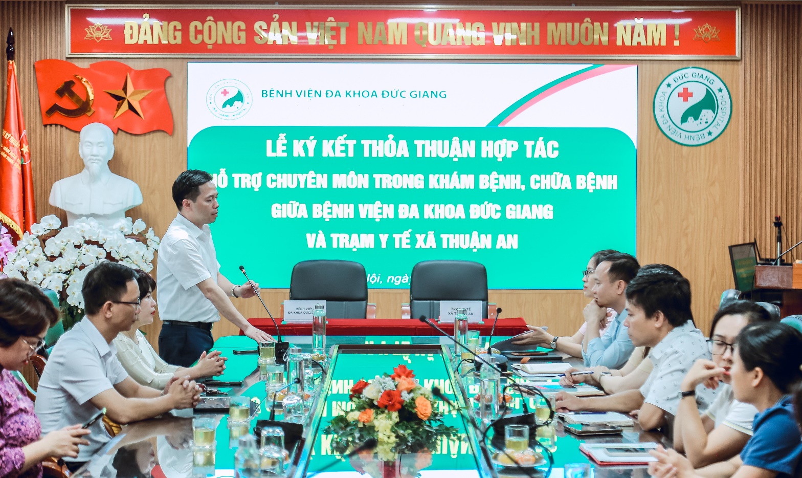 A person standing in front of a group of people sitting around a table  AI-generated content may be incorrect.