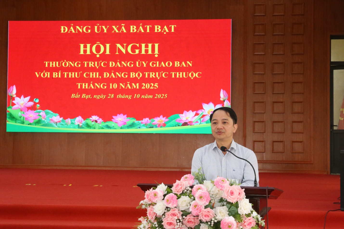 A person standing at a podium with a microphone  Description automatically generated