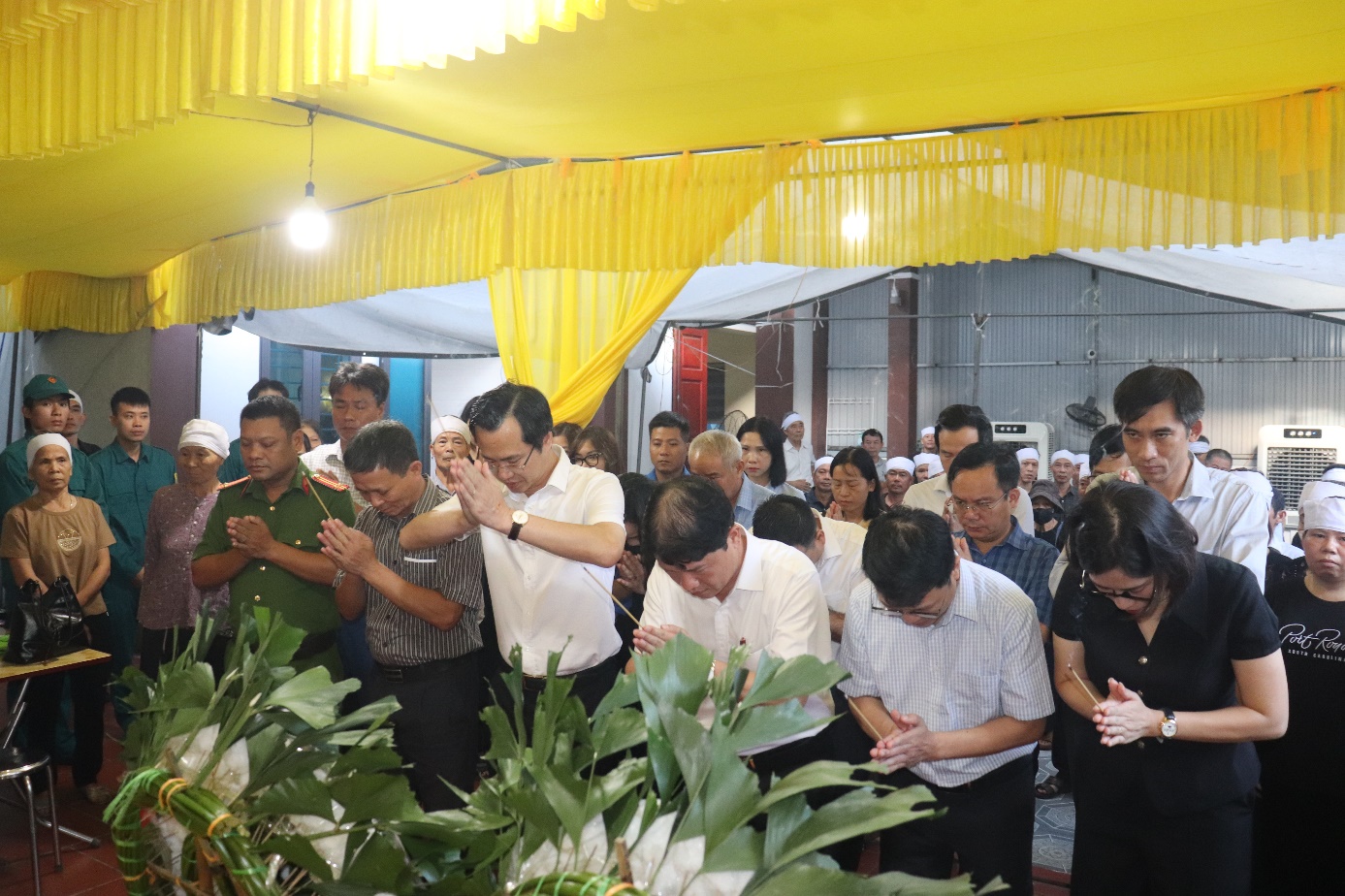 A group of people praying in a room  AI-generated content may be incorrect.