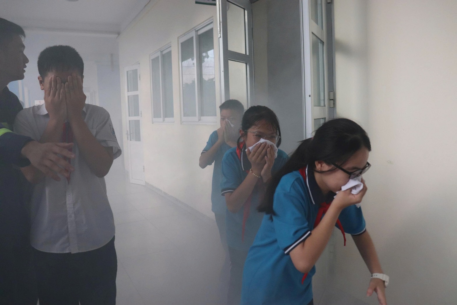 A group of people blowing their nose in a room with smoke  AI-generated content may be incorrect.