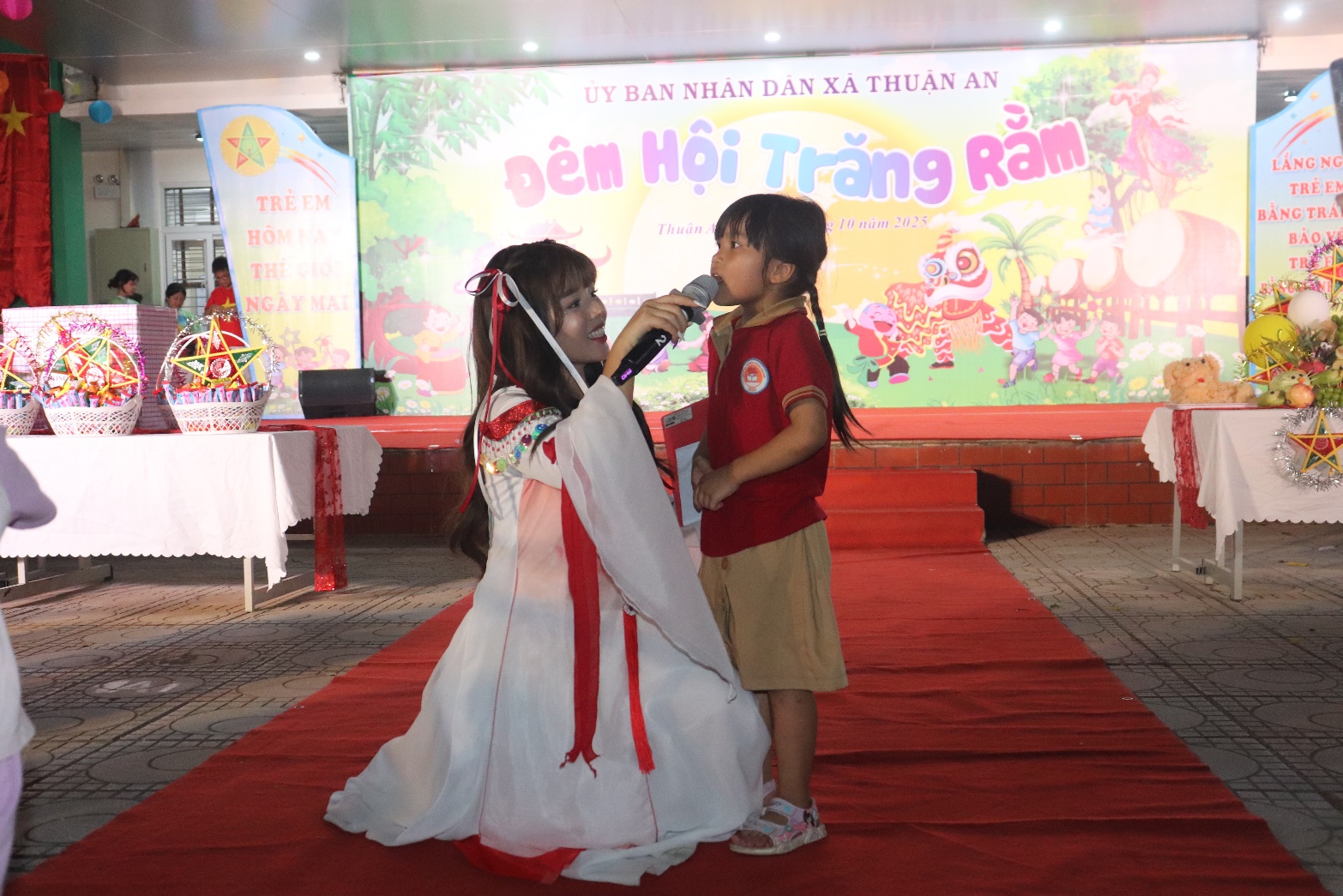 A child holding a microphone to a child  AI-generated content may be incorrect.