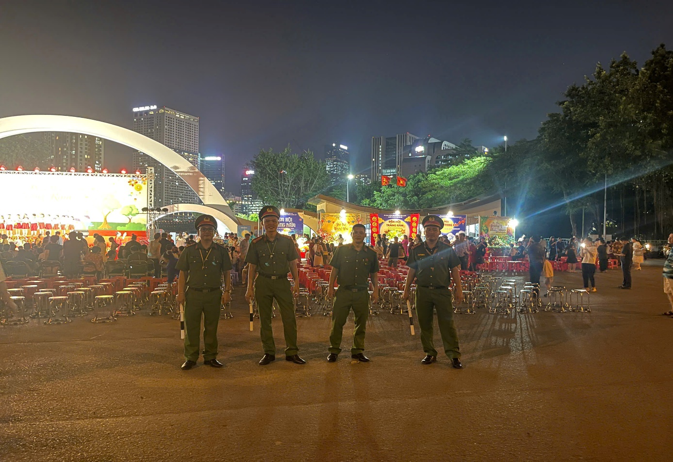 A group of people in uniform standing in front of a crowd of people  AI-generated content may be incorrect.