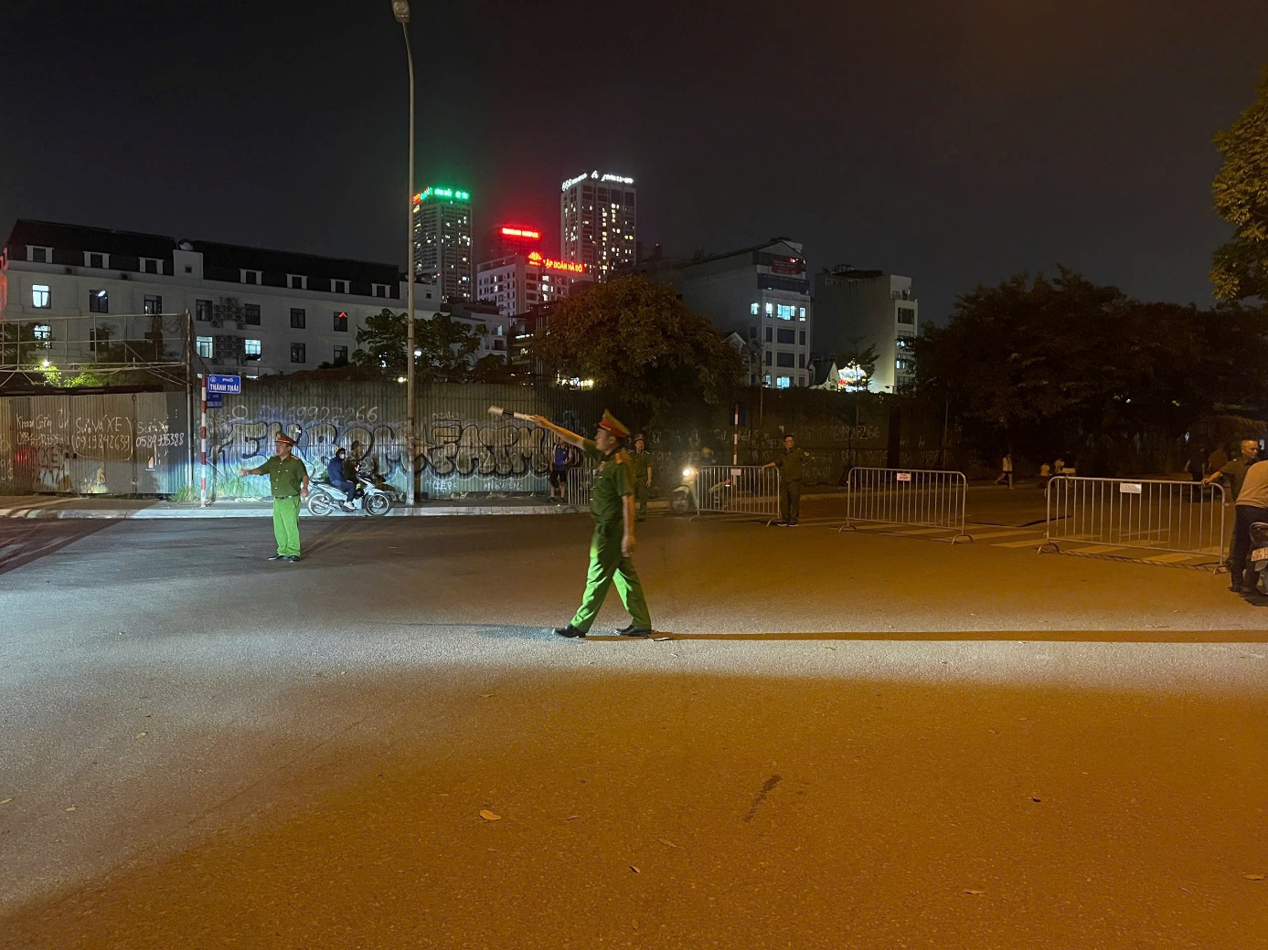 A group of men in green uniforms standing in a street  AI-generated content may be incorrect.