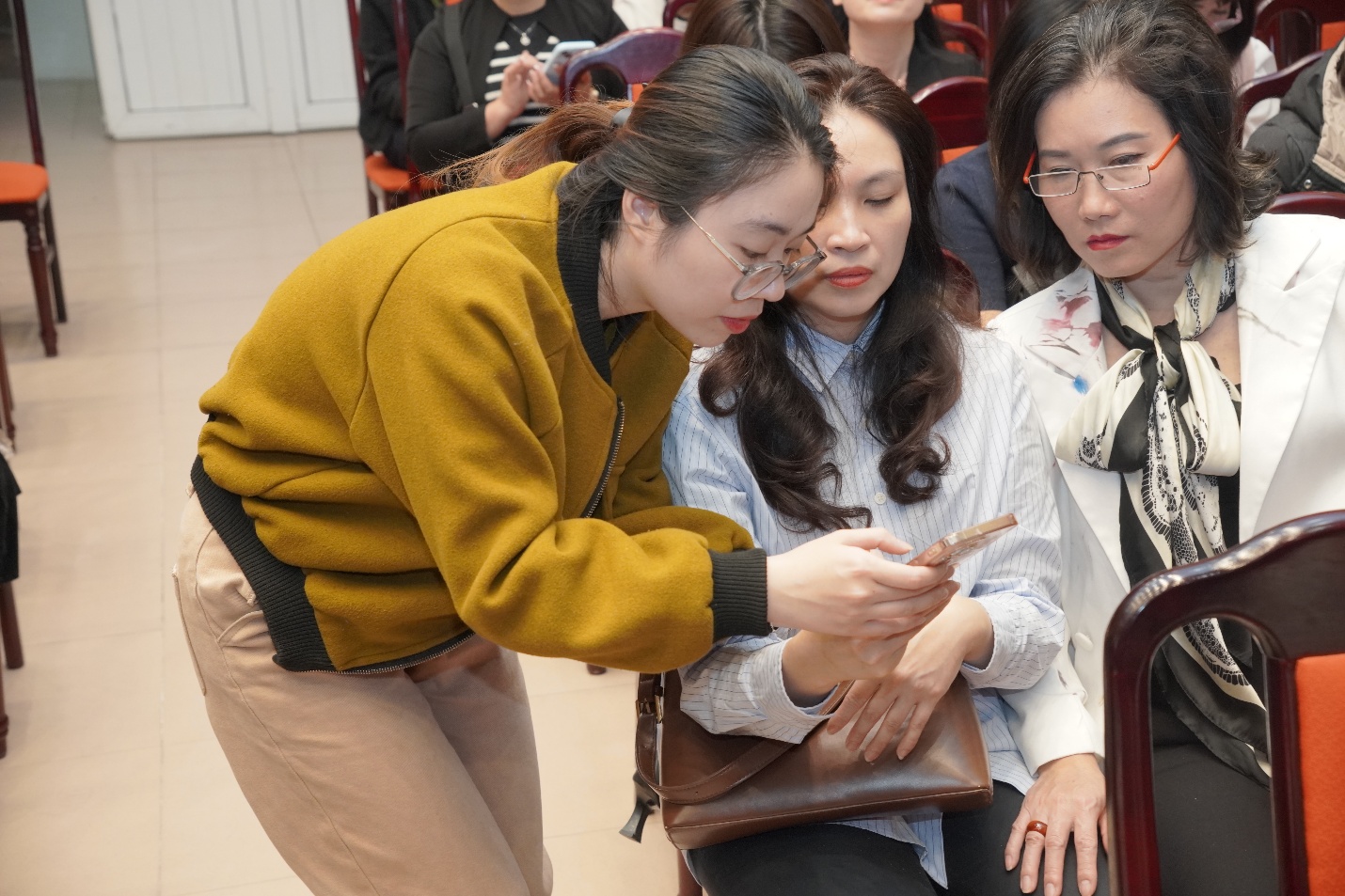 A person looking at a phone  AI-generated content may be incorrect.