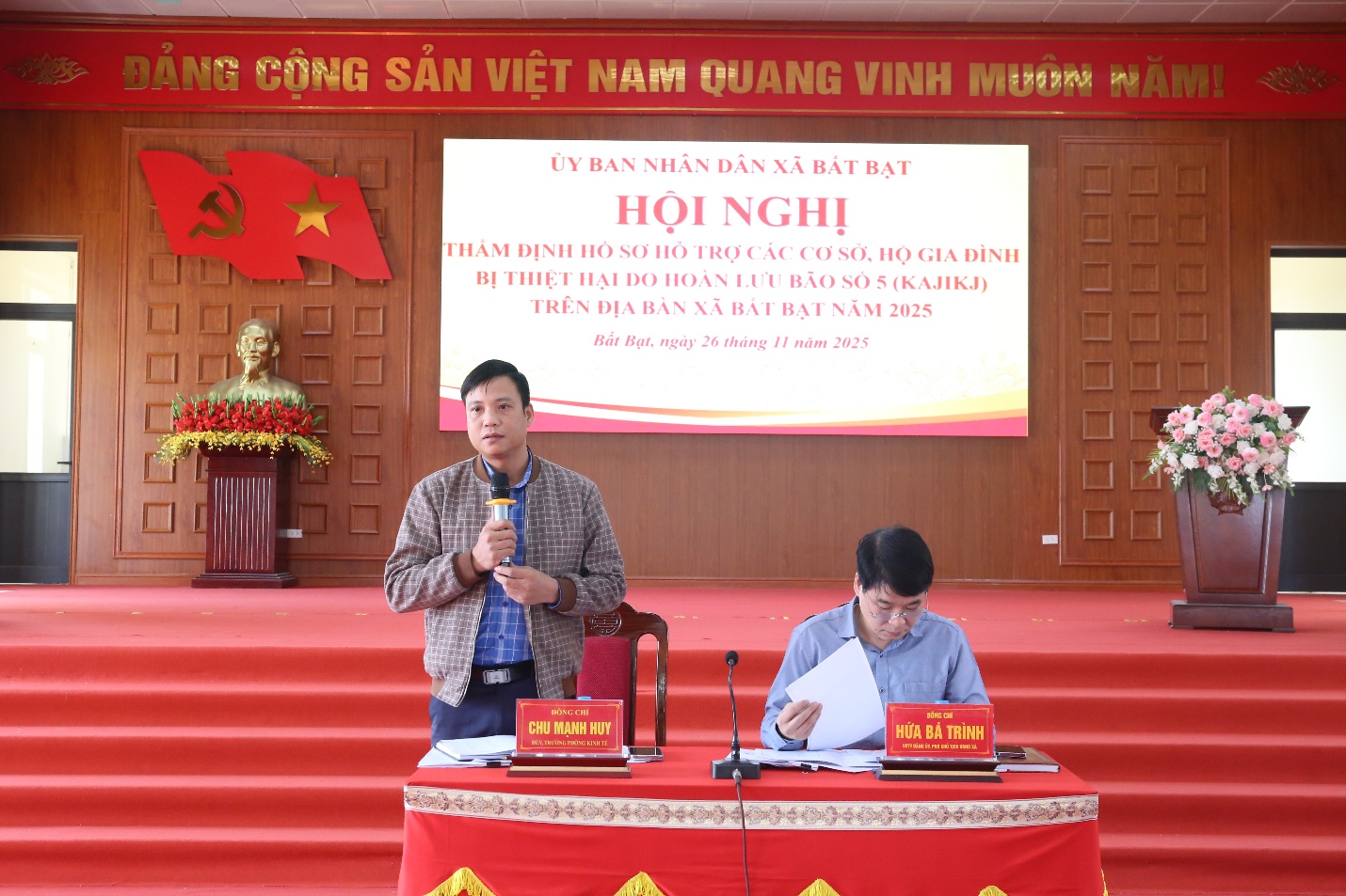 A person standing at a podium with a microphone  Description automatically generated