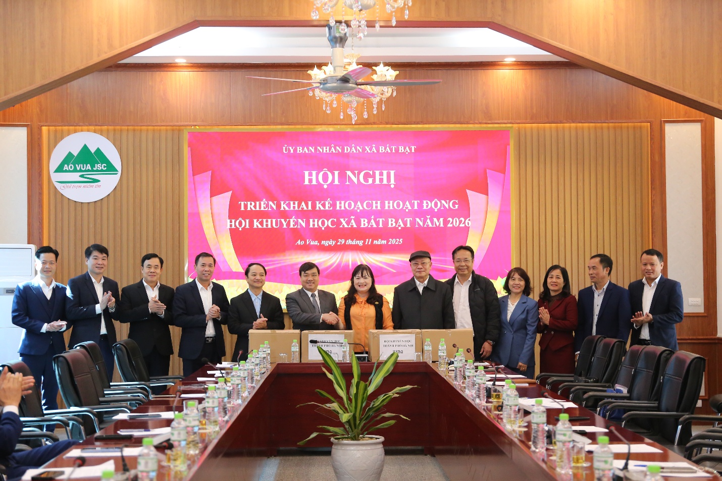 A group of people standing in a room  Description automatically generated