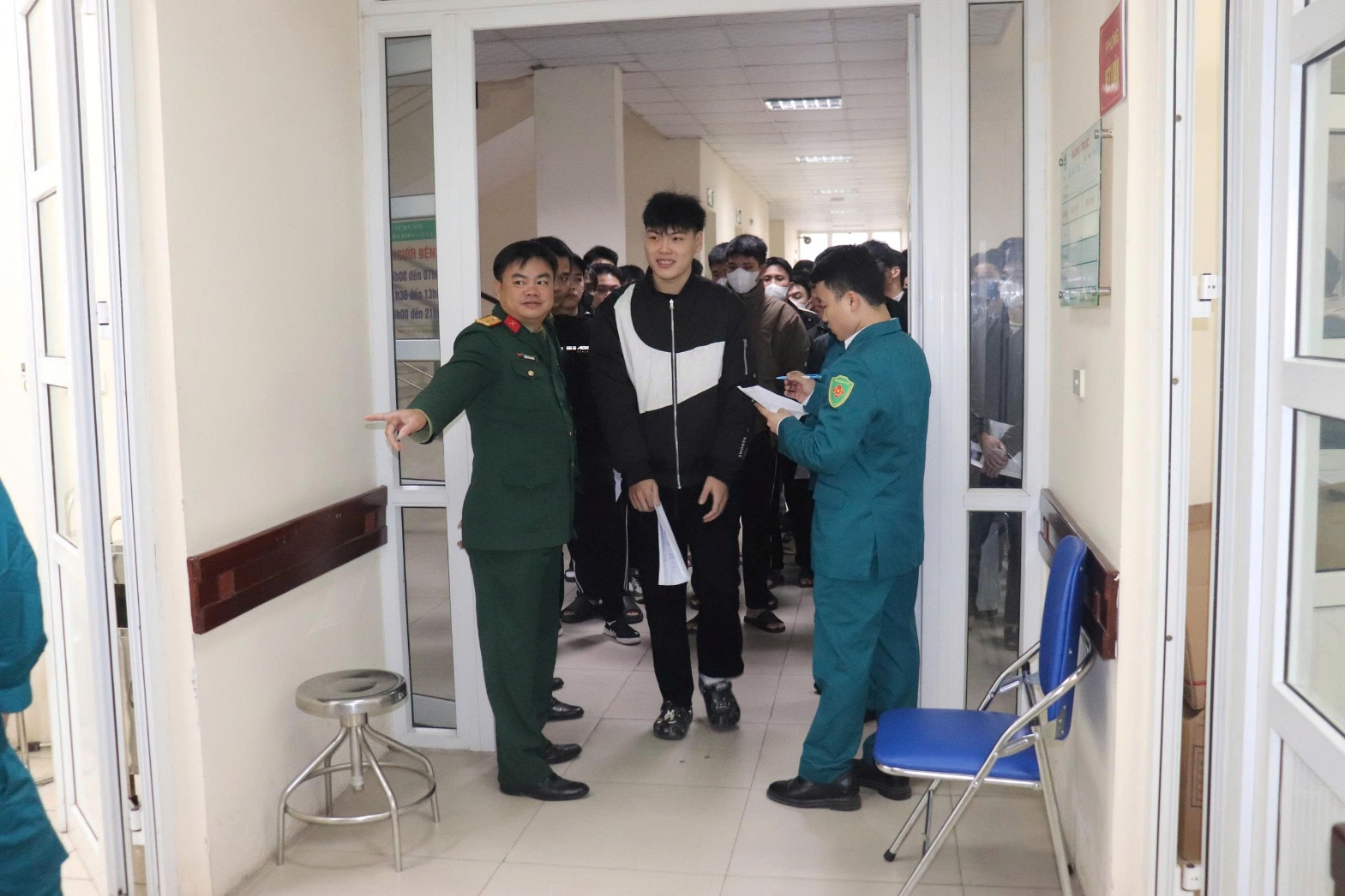 A group of people in a hallway  AI-generated content may be incorrect.