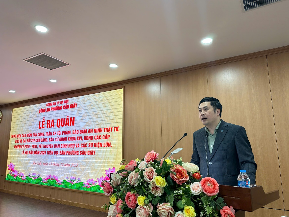 A person standing at a podium with a microphone and flowers  AI-generated content may be incorrect.