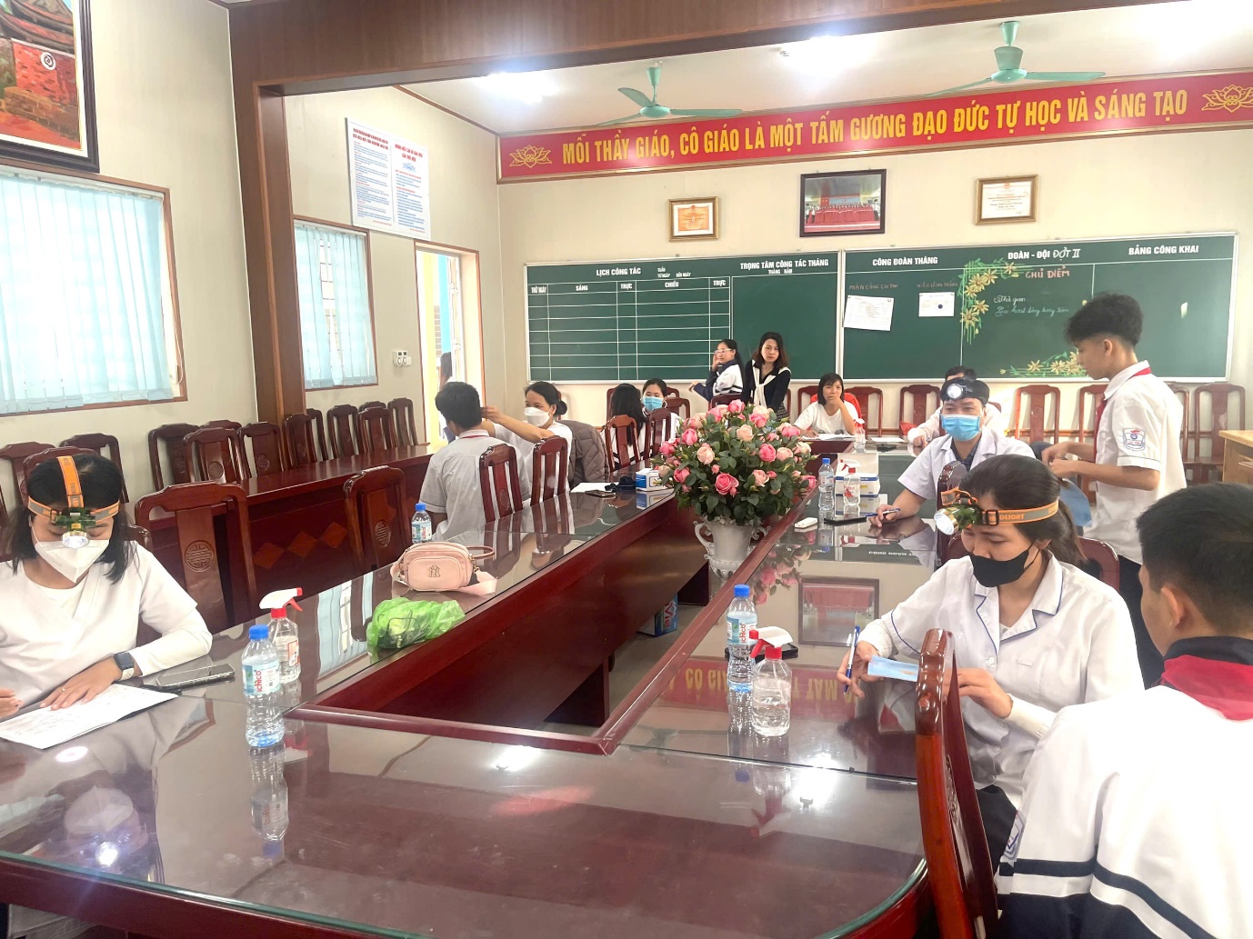 A group of people sitting at a table  AI-generated content may be incorrect.