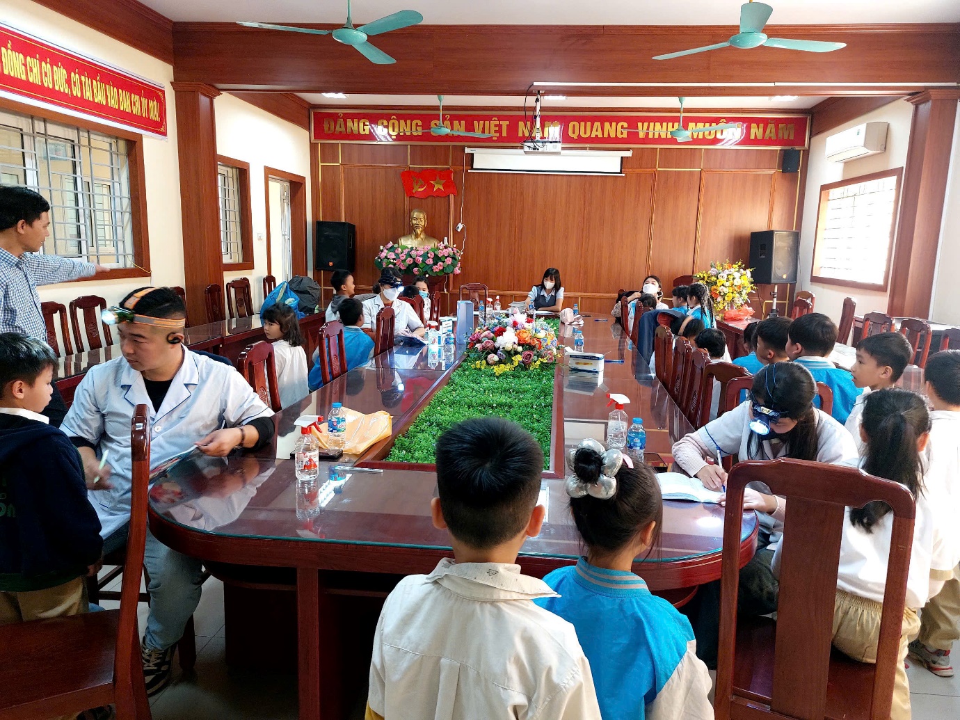 A group of people sitting at a table  AI-generated content may be incorrect.