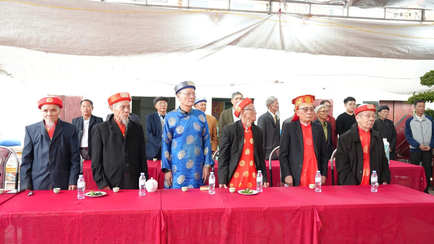 A group of people standing in front of a table  AI-generated content may be incorrect.