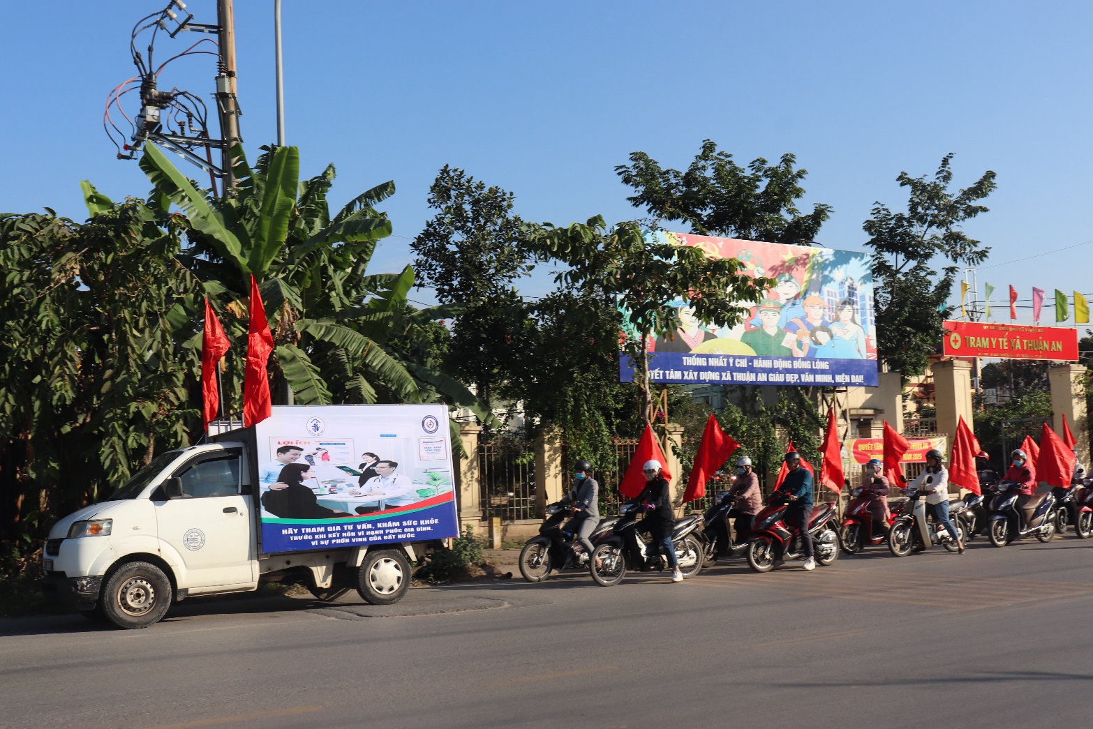 A group of people on motorcycles and a truck with flags  AI-generated content may be incorrect.
