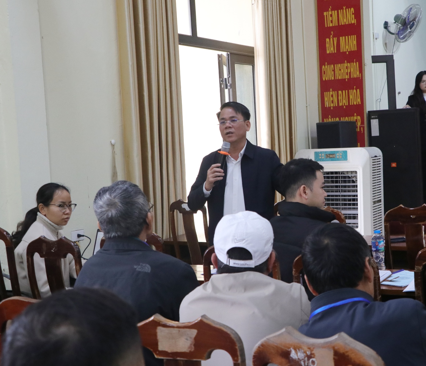 A person speaking to a group of people  AI-generated content may be incorrect.