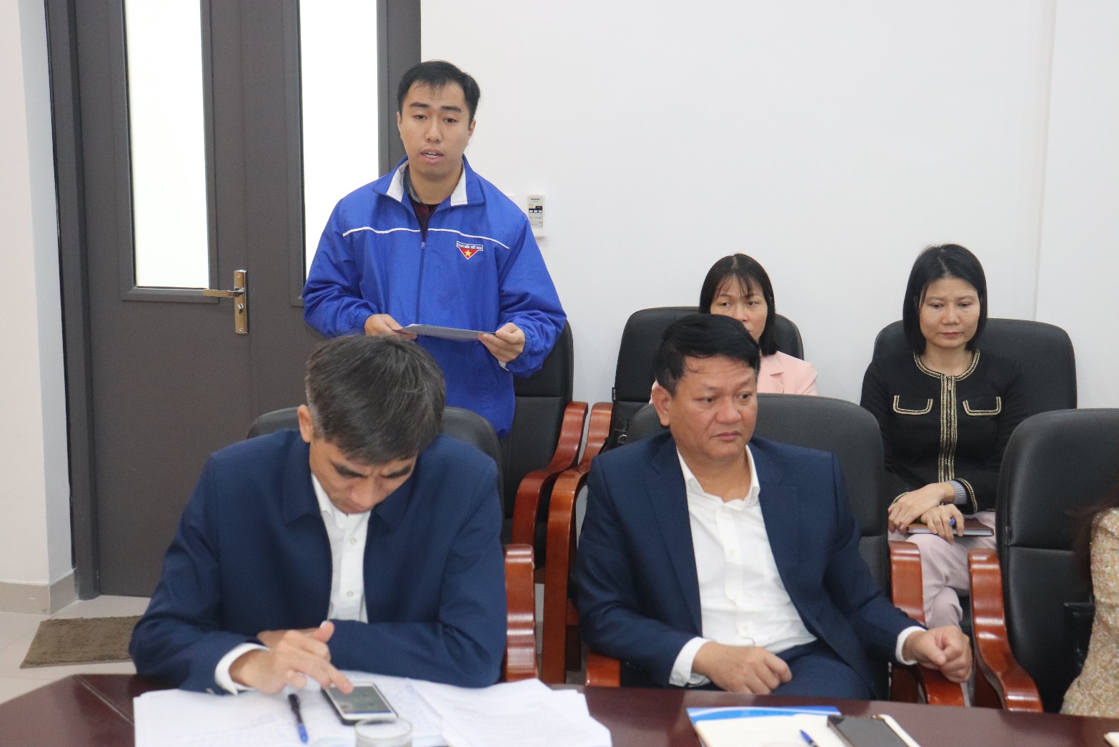 A group of people sitting at a table  AI-generated content may be incorrect.