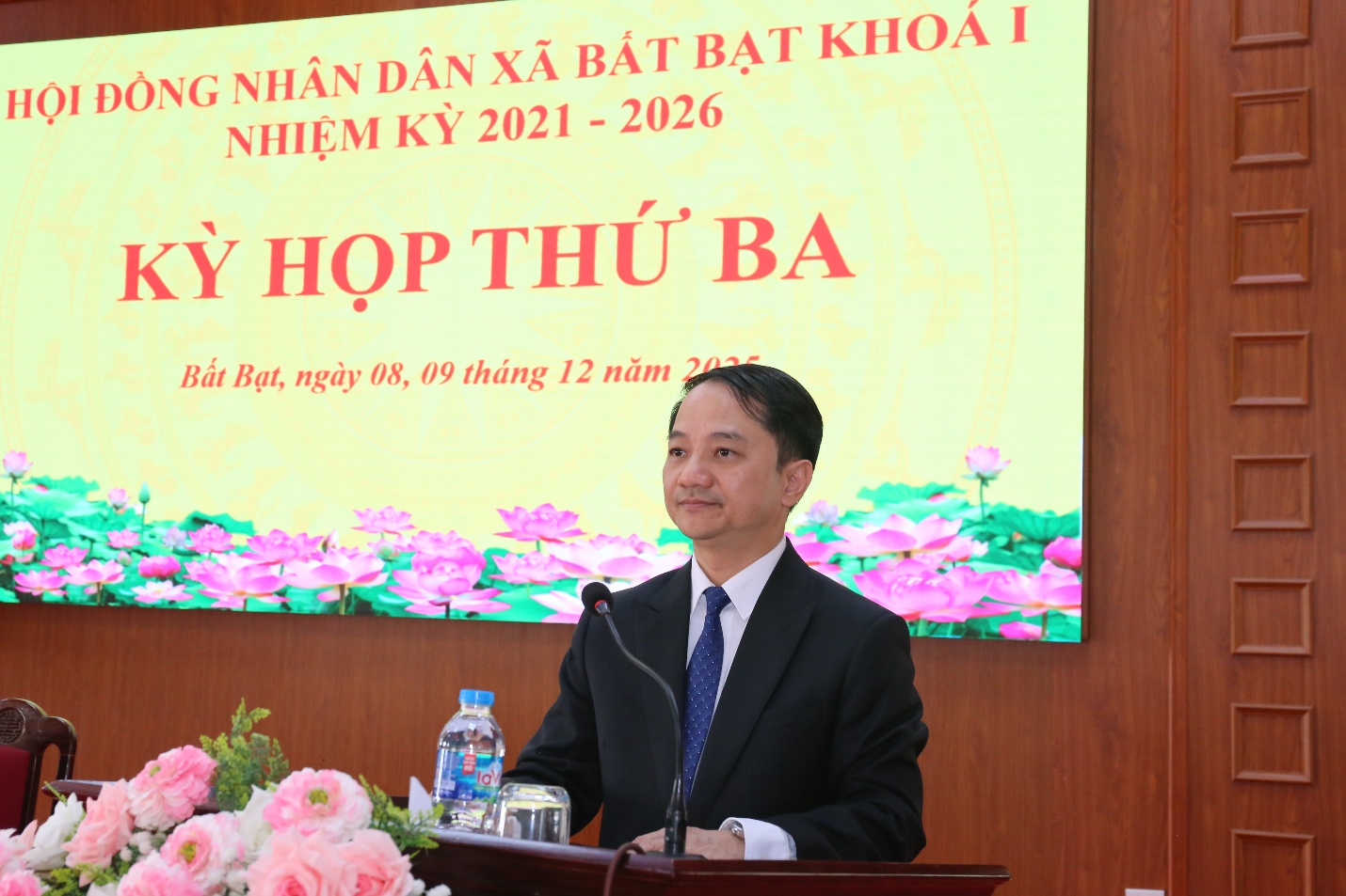 A person standing at a podium  Description automatically generated