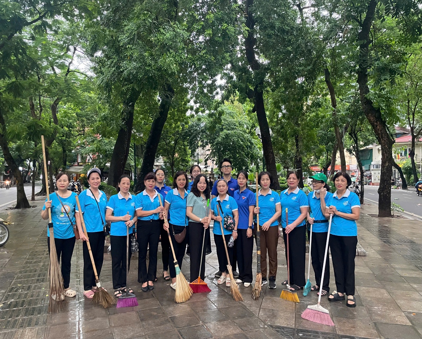 A group of people holding brooms  AI-generated content may be incorrect.