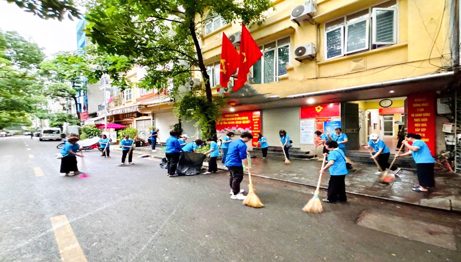 A group of people sweeping the street  AI-generated content may be incorrect.