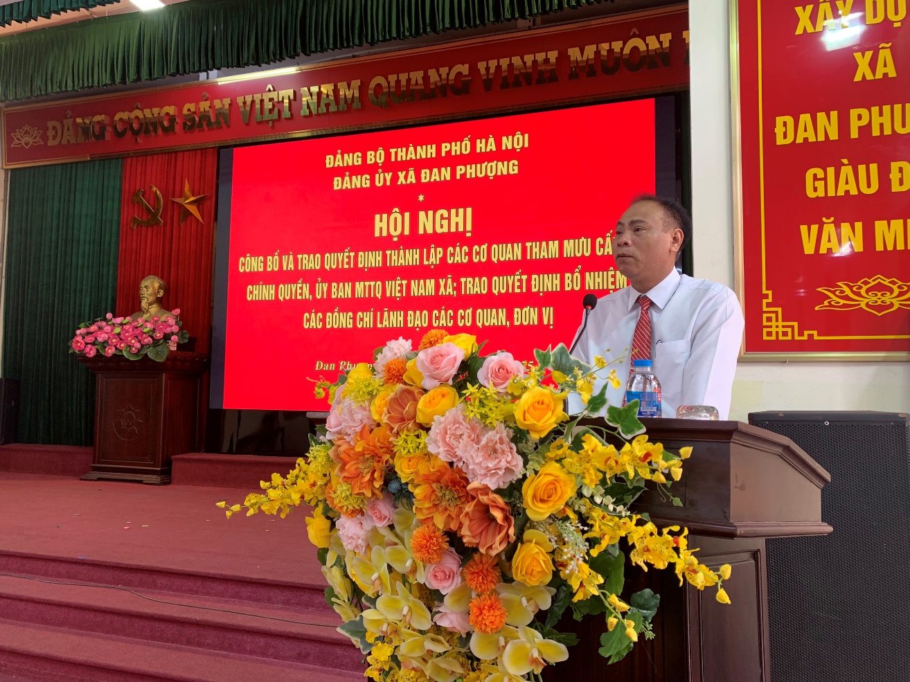A person sitting at a podium with a large bouquet of flowers  AI-generated content may be incorrect.