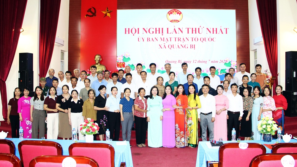 A group of people standing in front of a banner  AI-generated content may be incorrect.