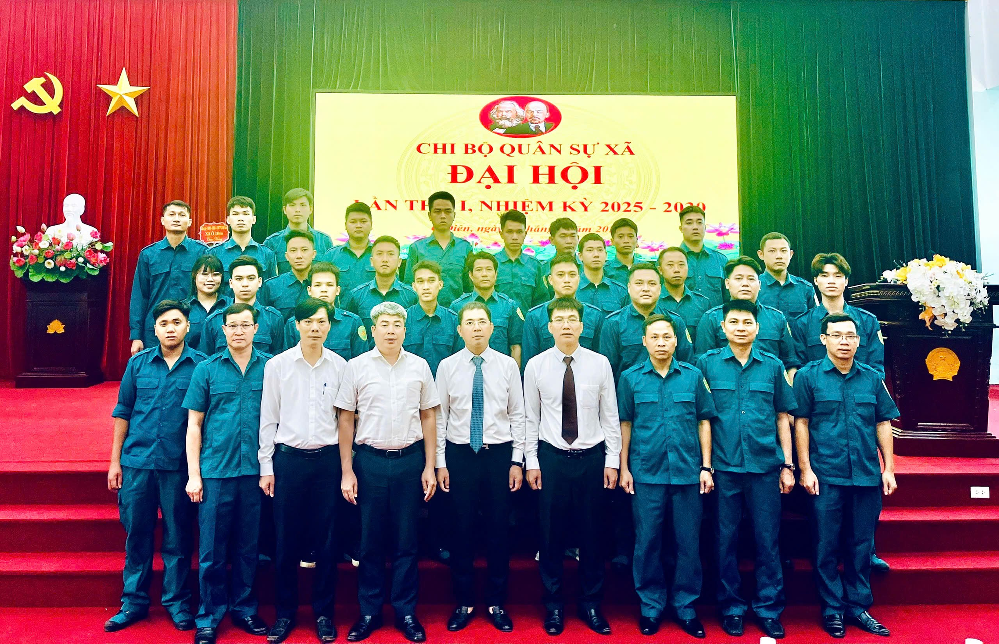 A group of people standing in front of a stage  Description automatically generated
