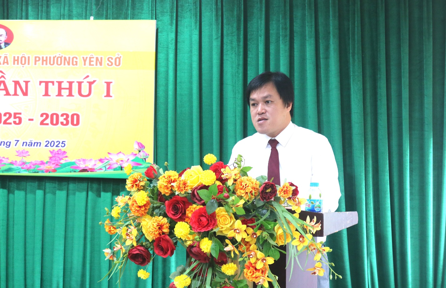A person standing at a podium with a bouquet of flowers  AI-generated content may be incorrect.