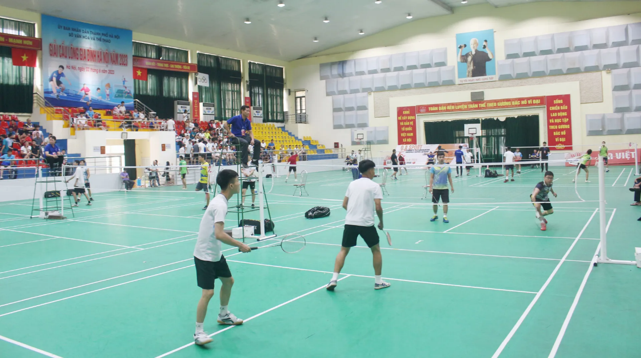 A group of people playing badminton  AI-generated content may be incorrect.