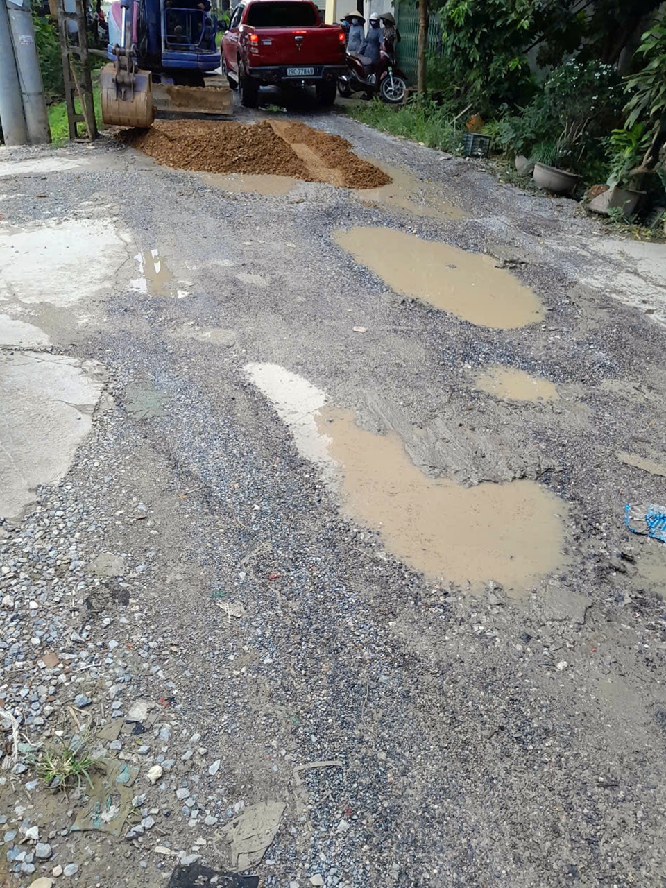 A dirt and water puddles on a road  AI-generated content may be incorrect.