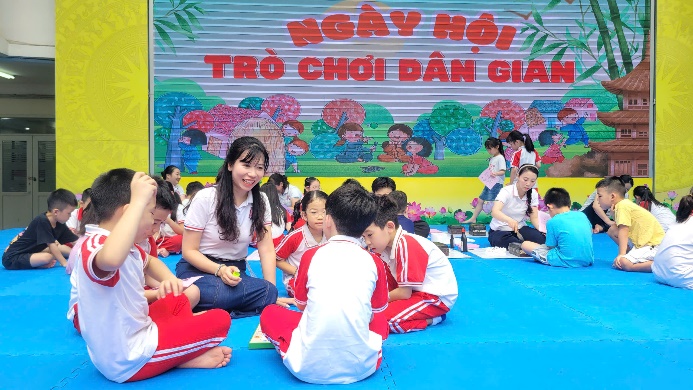 A group of children sitting on a blue mat  AI-generated content may be incorrect.