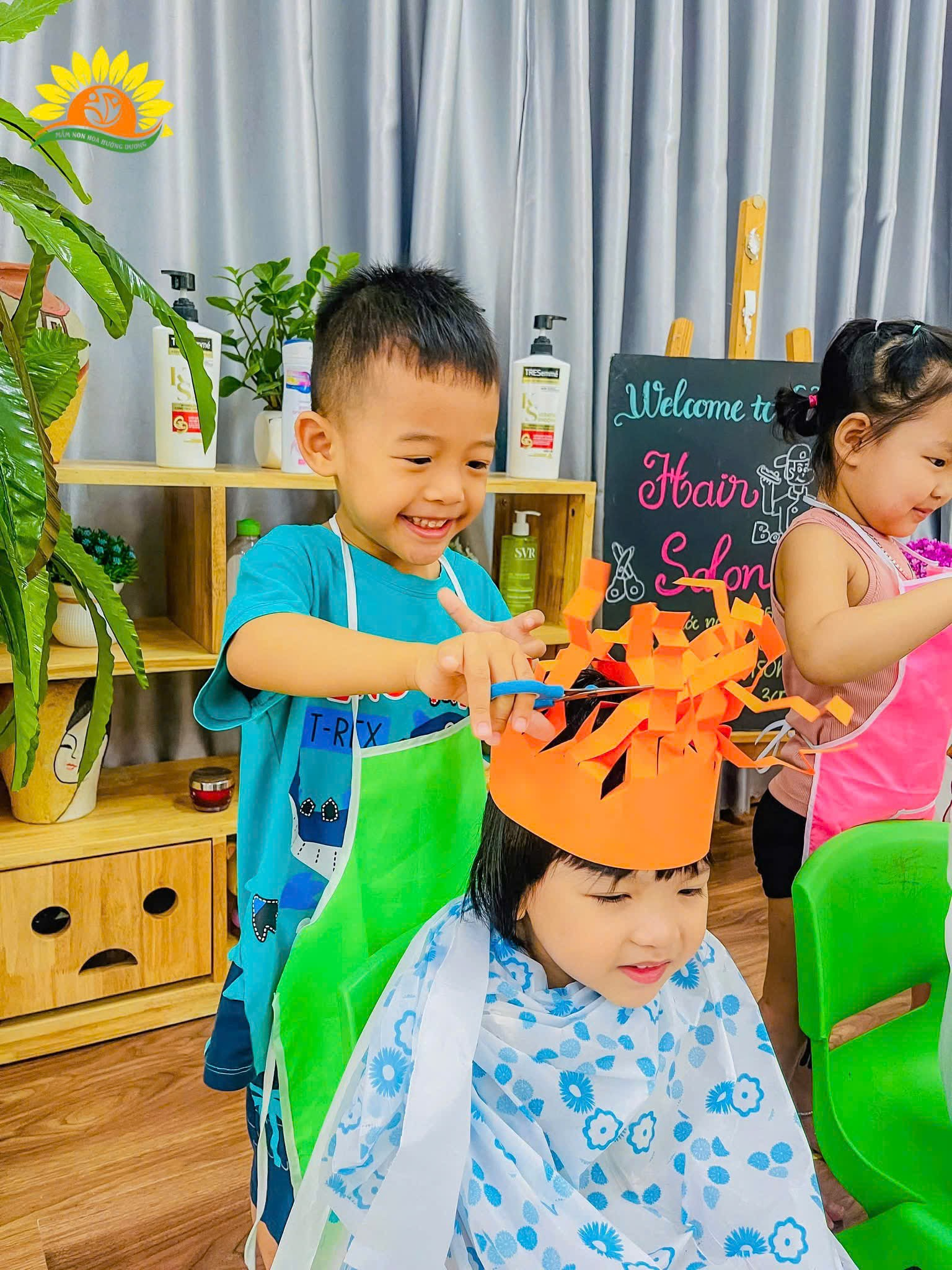 A group of kids wearing an orange hat  Description automatically generated