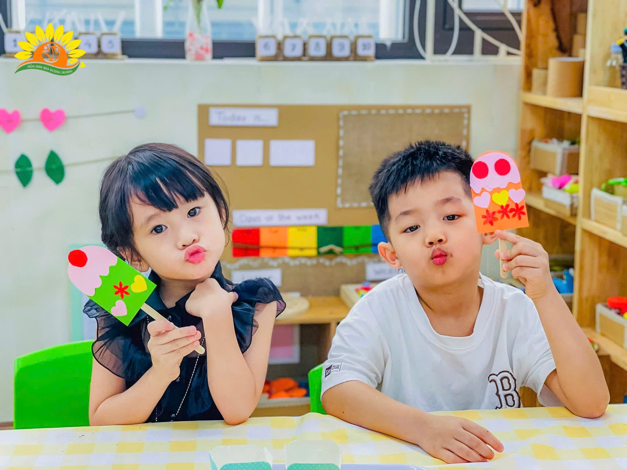 A child and child holding popsicles  Description automatically generated