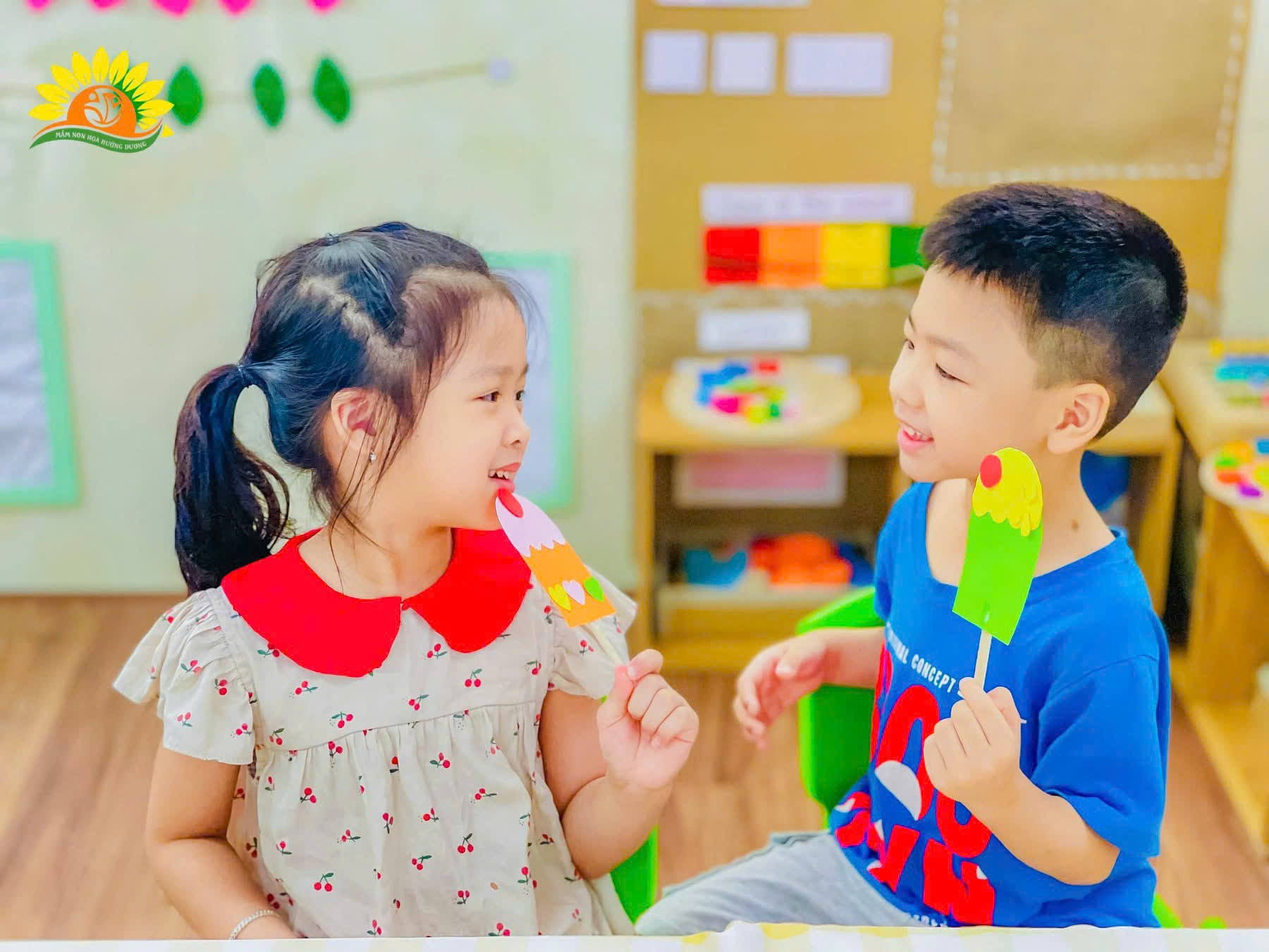 A child and child eating ice cream  Description automatically generated