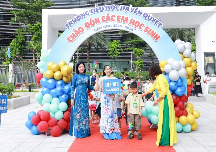 A group of people standing under a sign  Description automatically generated