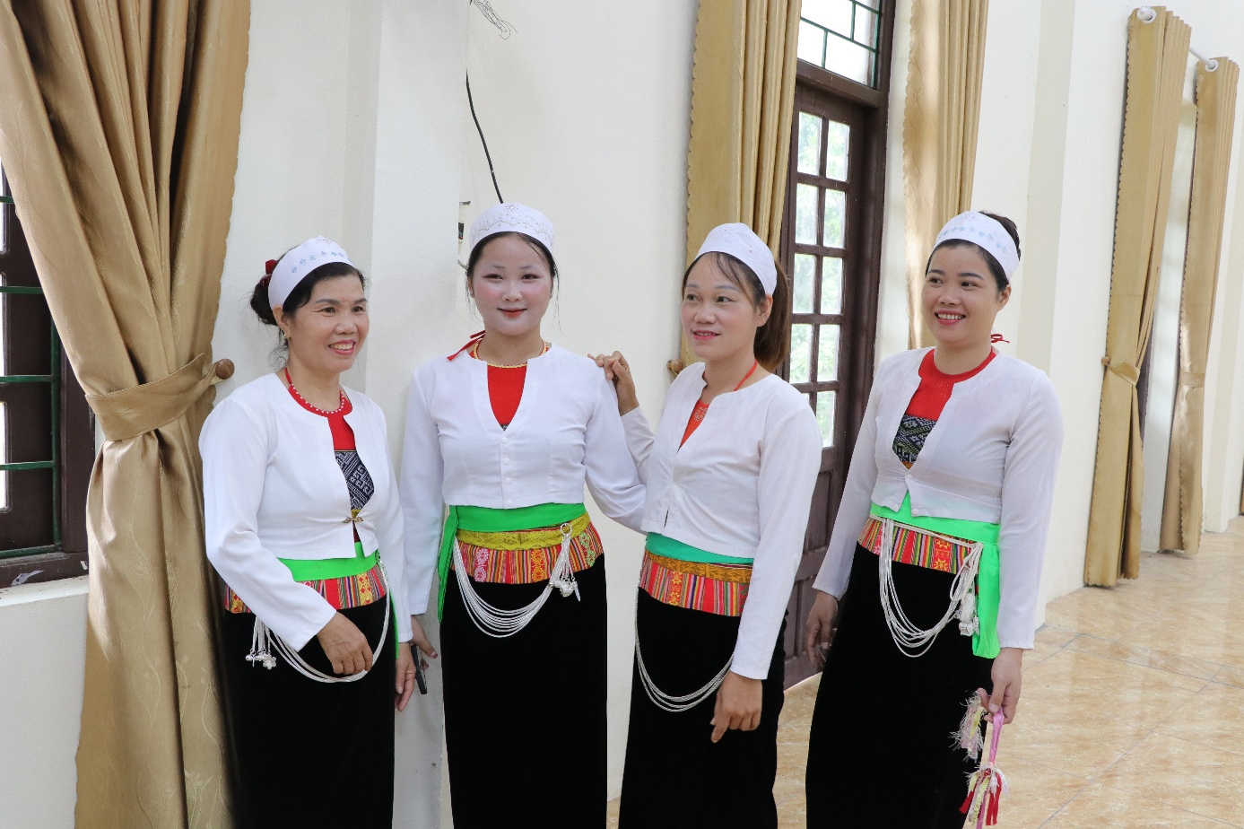 A group of women wearing white shirts and black skirts  AI-generated content may be incorrect.