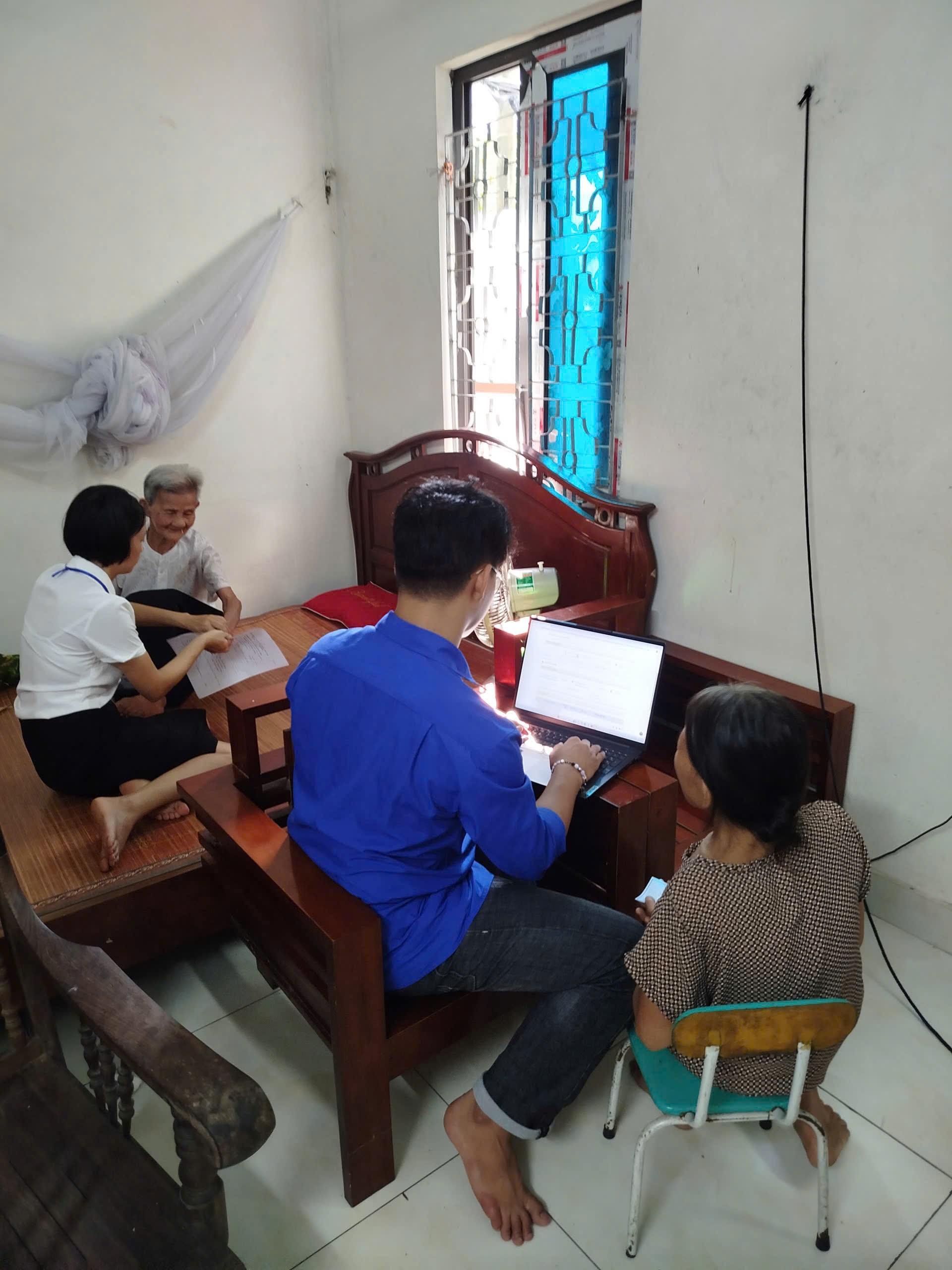 A group of people sitting at a desk  Description automatically generated
