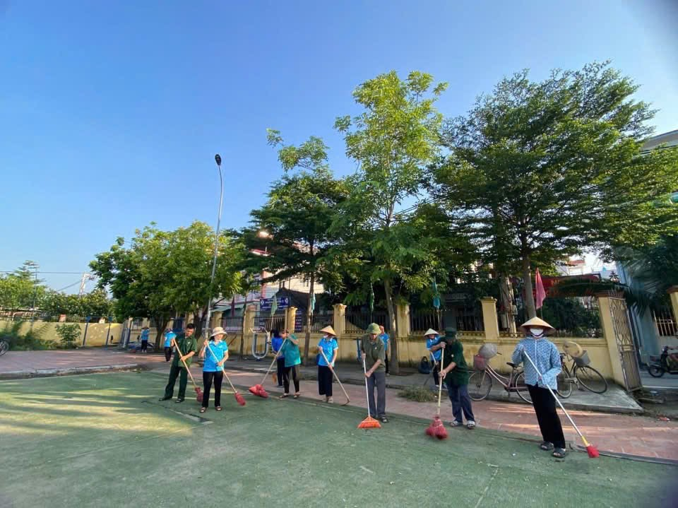 A group of people holding brooms  Description automatically generated