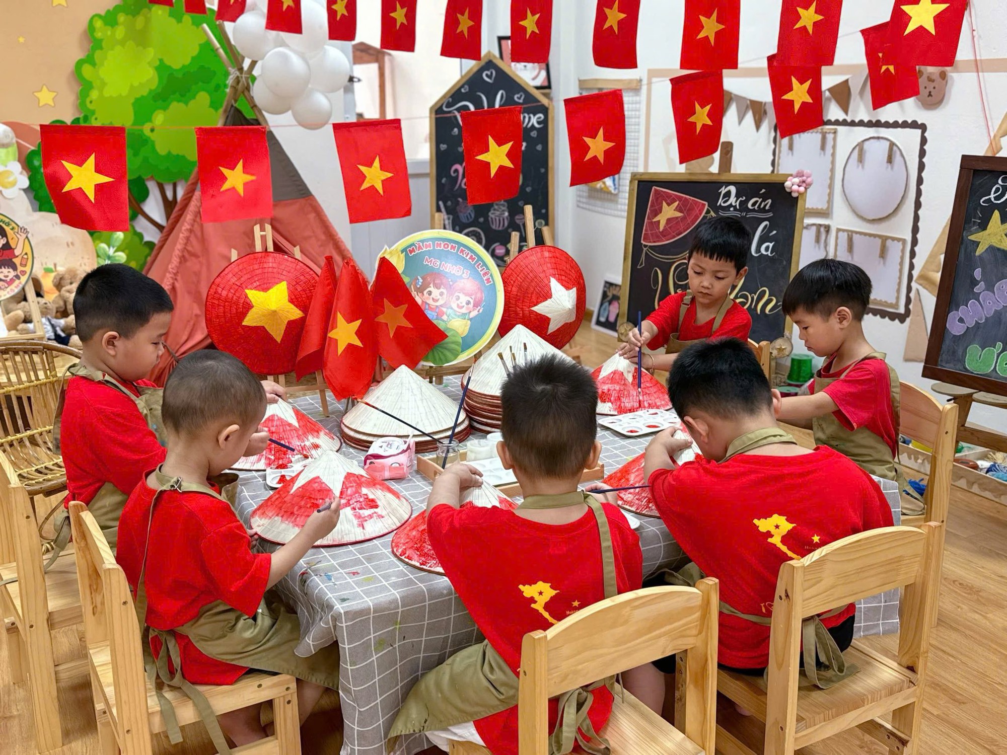 A group of boys sitting at a table with flags  AI-generated content may be incorrect.
