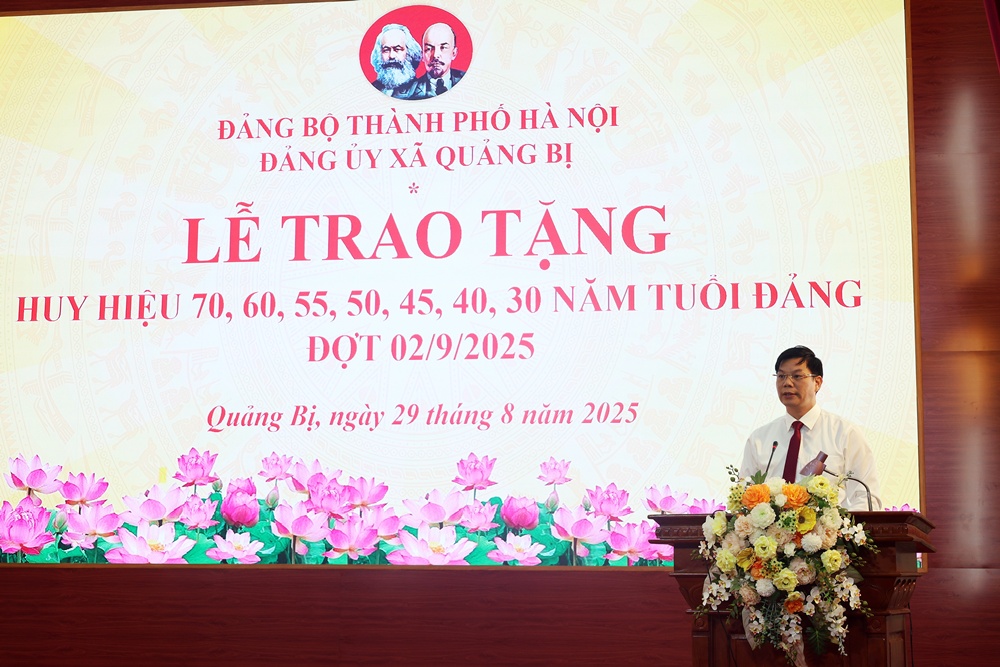 A person standing at a podium with flowers on it  AI-generated content may be incorrect.
