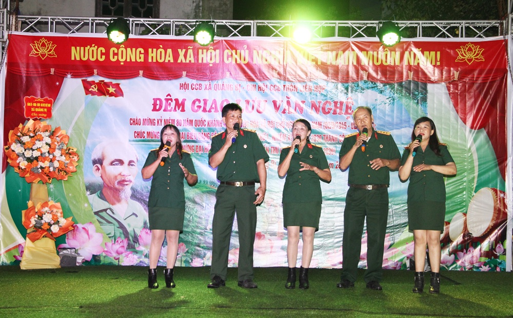 A group of people singing on a stage  AI-generated content may be incorrect.