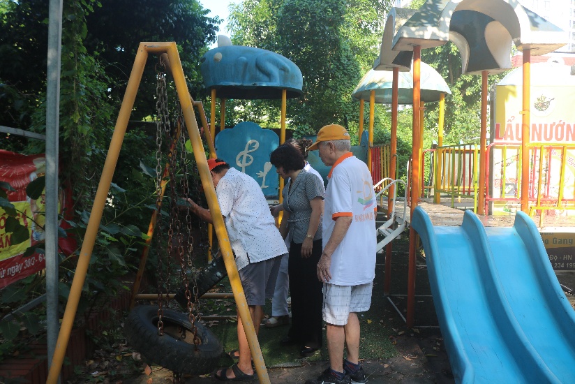 A group of people standing in a playground  AI-generated content may be incorrect.
