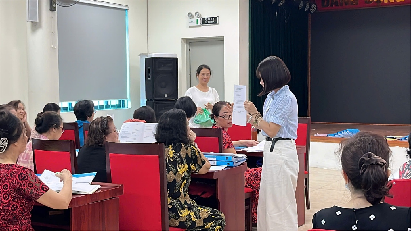 A person standing in front of a group of people  Description automatically generated