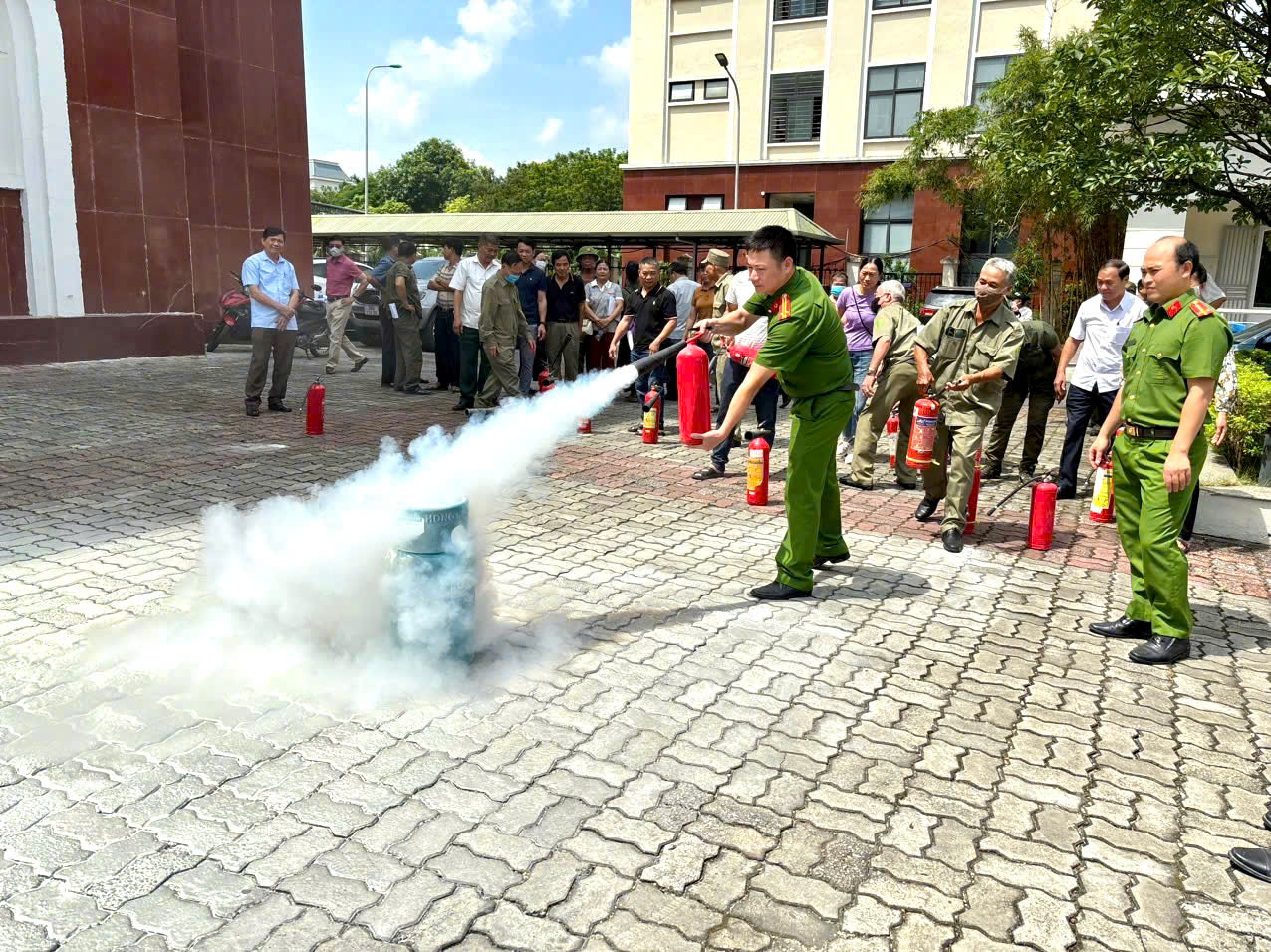 A person in green uniform spraying a fire extinguisher  AI-generated content may be incorrect.