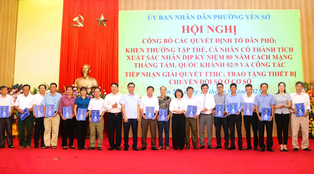A group of people standing in front of a banner  AI-generated content may be incorrect.