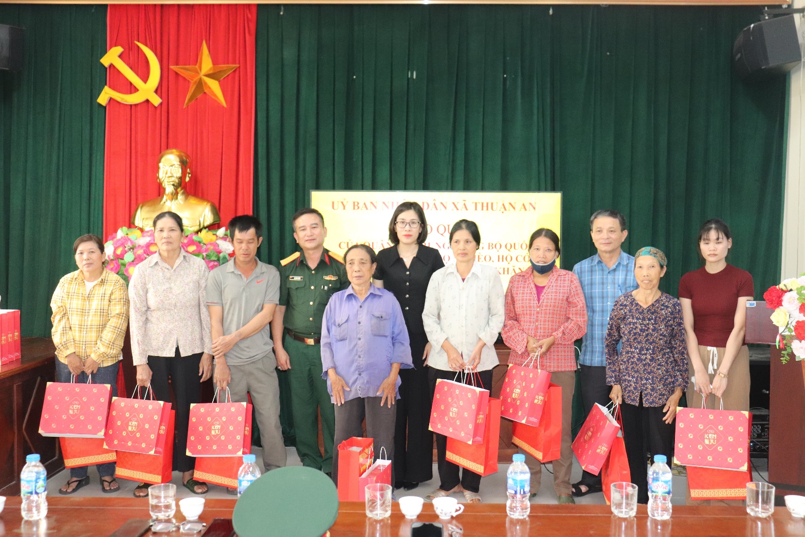 A group of people standing in front of a red and green curtain  AI-generated content may be incorrect.