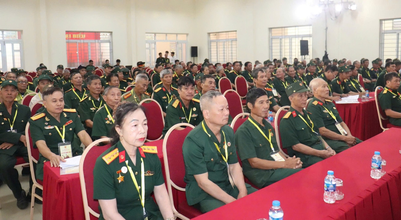 A group of people in uniform sitting in a room  AI-generated content may be incorrect.